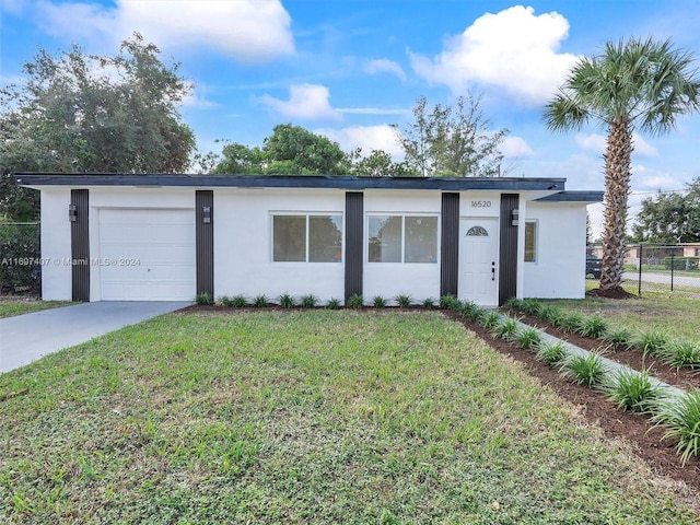 ranch-style home with a front lawn and a garage