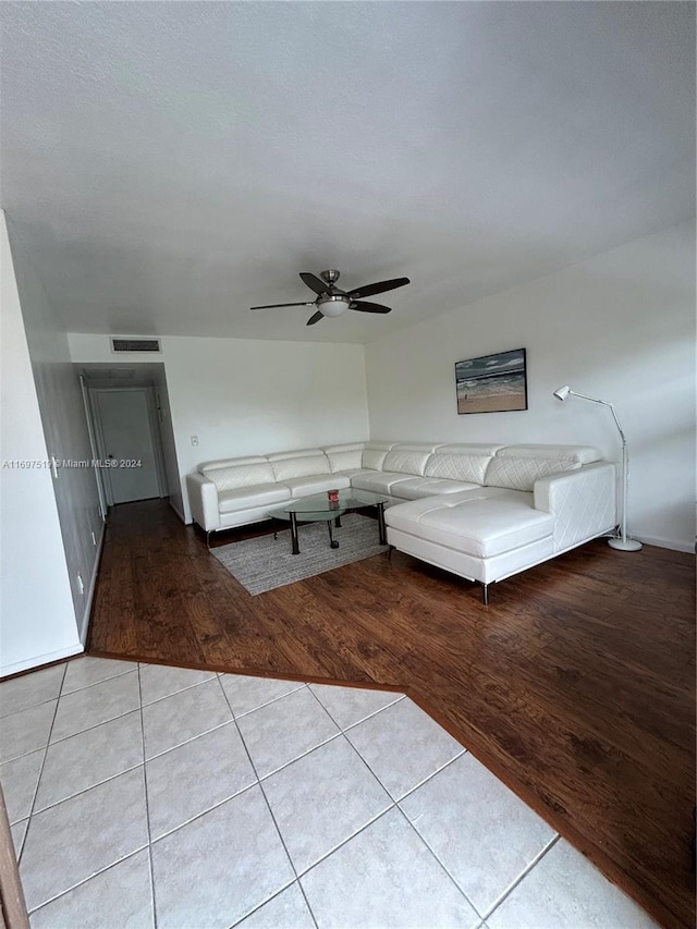 unfurnished living room with ceiling fan and light hardwood / wood-style floors