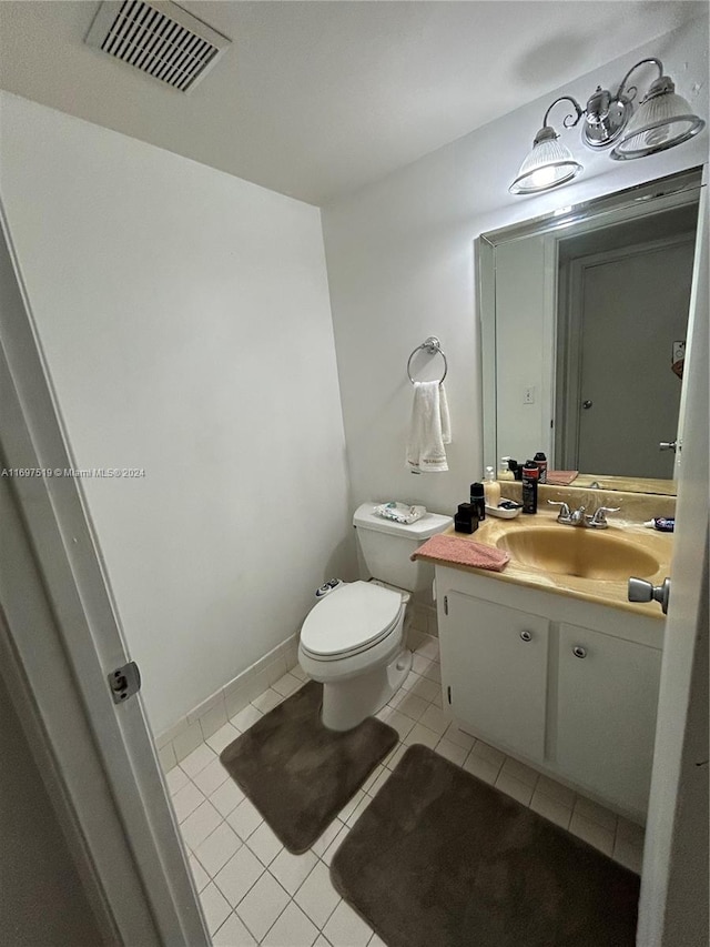 bathroom featuring toilet, vanity, and tile patterned floors