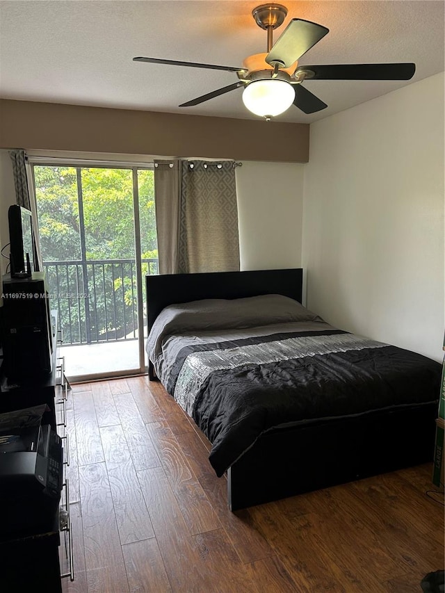 bedroom featuring access to outside, a textured ceiling, hardwood / wood-style flooring, and ceiling fan