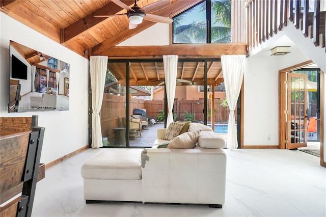 living room with ceiling fan, plenty of natural light, beamed ceiling, and wooden ceiling