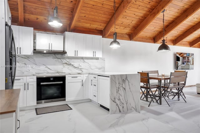 kitchen with white cabinets, appliances with stainless steel finishes, hanging light fixtures, and beamed ceiling