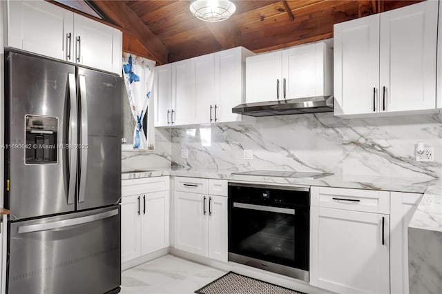 kitchen featuring light stone countertops, stainless steel appliances, vaulted ceiling, wooden ceiling, and white cabinets