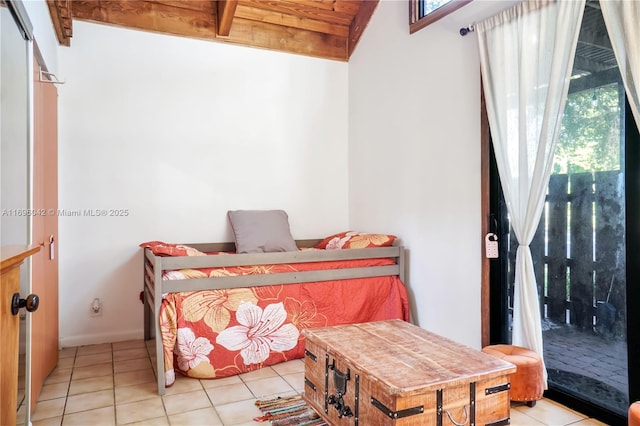 bedroom with light tile patterned floors and vaulted ceiling