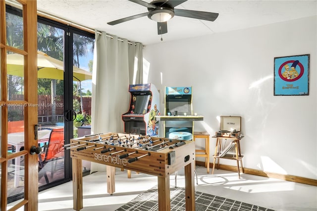 game room with ceiling fan, french doors, and concrete floors