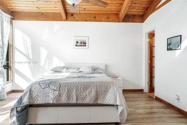 bedroom with vaulted ceiling with beams, light wood-type flooring, and wooden ceiling