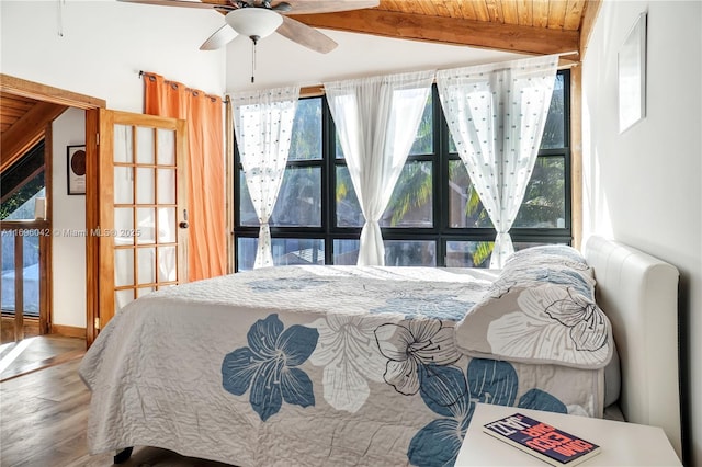 bedroom featuring beam ceiling, ceiling fan, hardwood / wood-style floors, and wooden ceiling