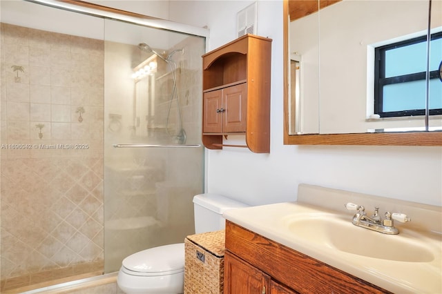 bathroom with walk in shower, vanity, and toilet