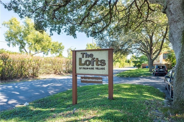 community / neighborhood sign with a lawn