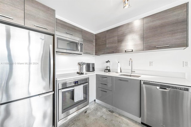 kitchen featuring dark brown cabinets, sink, and appliances with stainless steel finishes