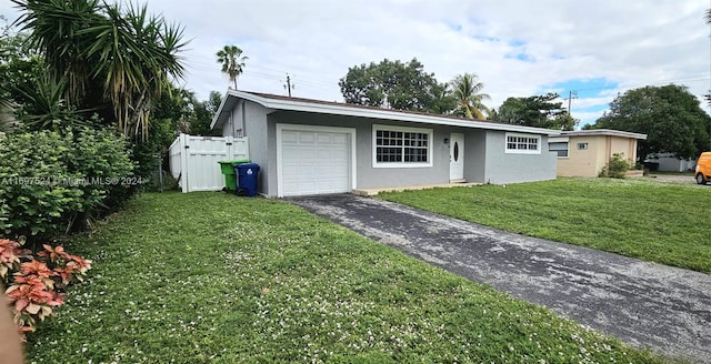 single story home with a front yard and a garage