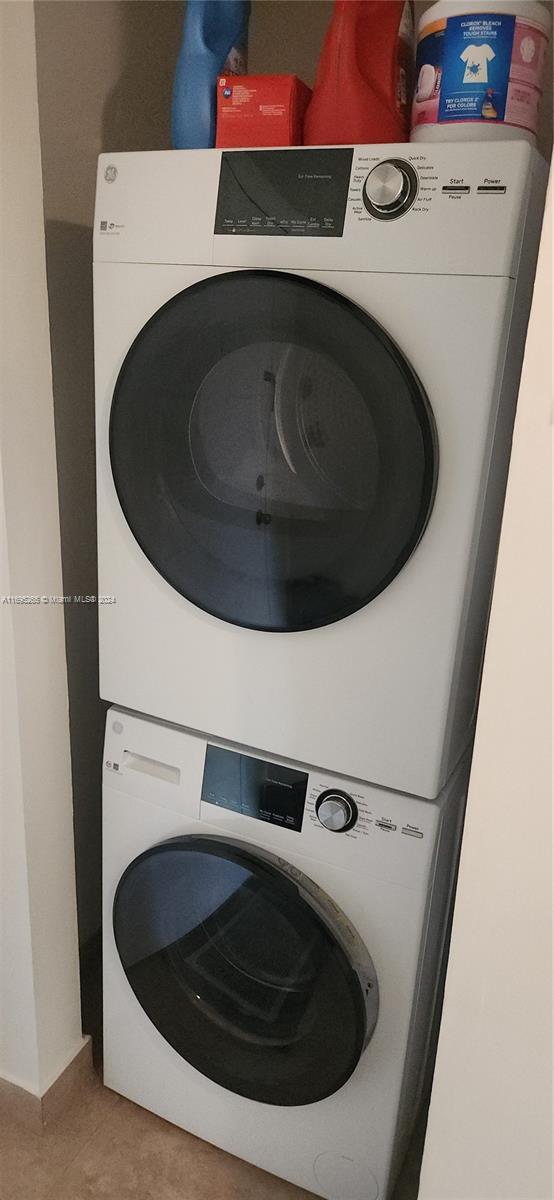 1201 S Ocean Dr Unit 304S, Hollywood, FL 33019 - laundry area with estacked washer and dryer and light tile patterned floors