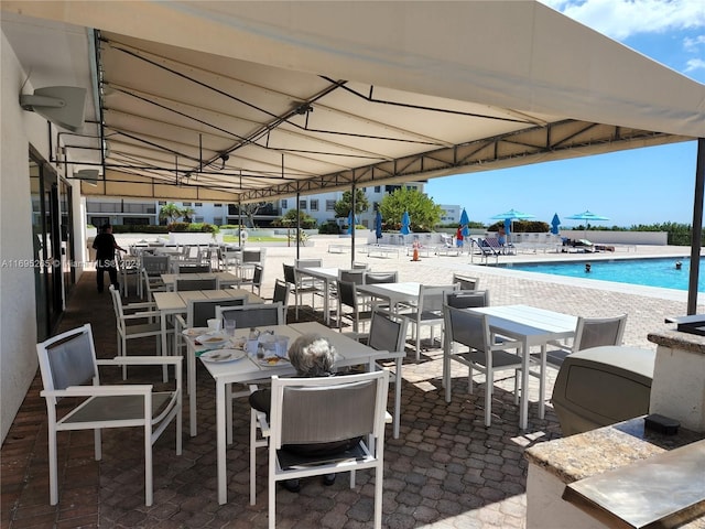 1201 S Ocean Dr Unit 304S, Hollywood, FL 33019 - view of patio / terrace featuring a community pool and outdoor dining area