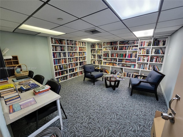 sitting room with a paneled ceiling and carpet floors