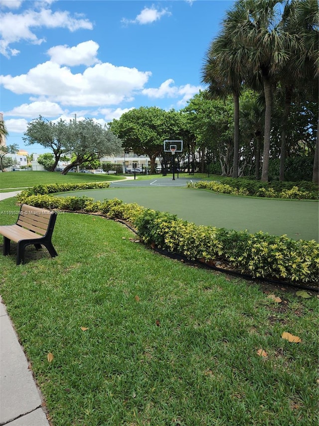 surrounding community with a lawn and basketball court