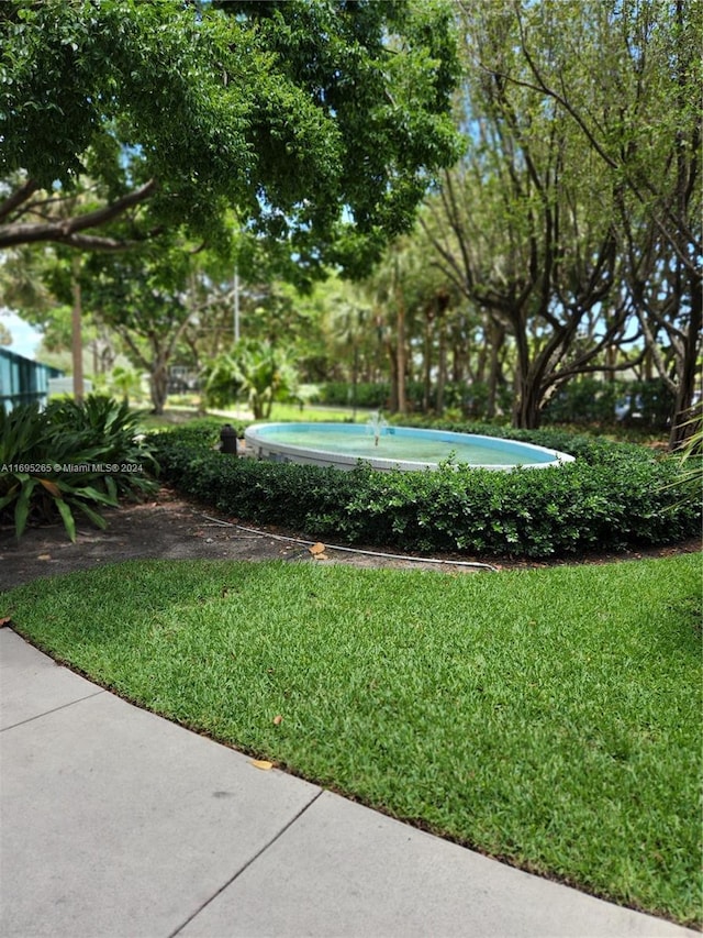 1201 S Ocean Dr Unit 304S, Hollywood, FL 33019 - view of grassy yard with view of wooded area