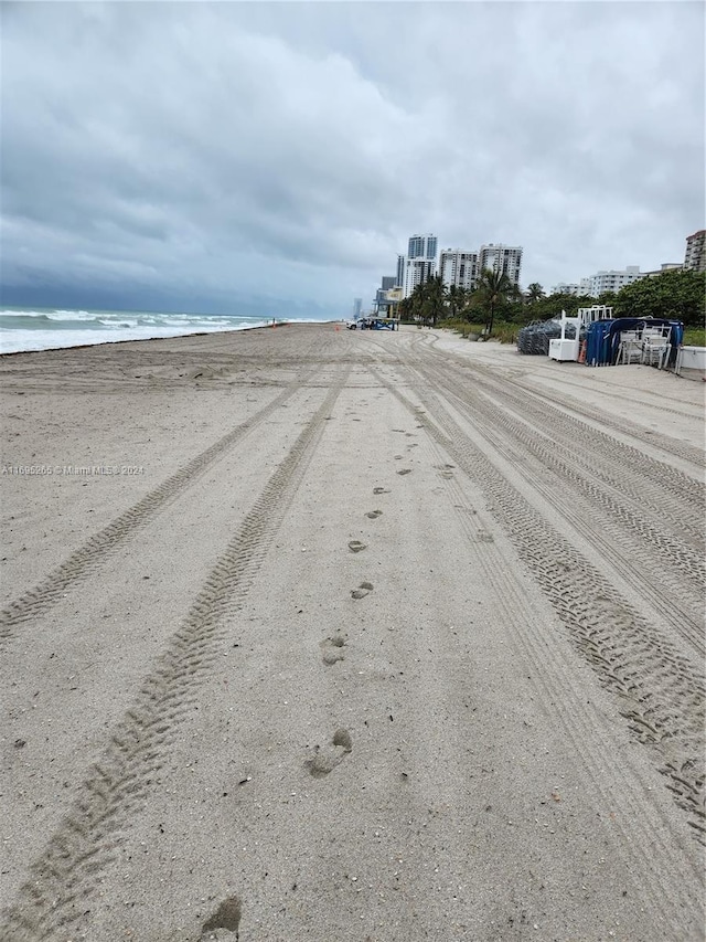 view of road featuring a water view and a view of the beach