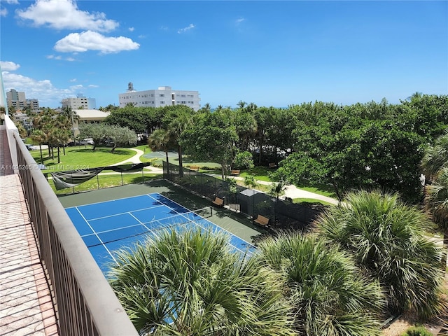 view of sport court with a lawn