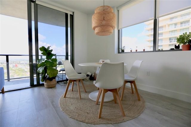 dining area featuring hardwood / wood-style floors and floor to ceiling windows