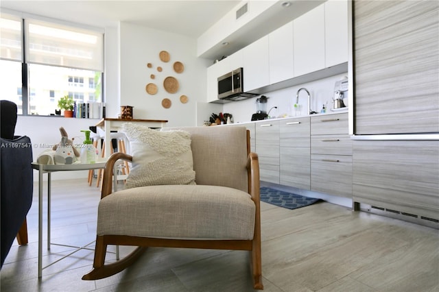 kitchen with white cabinetry and sink