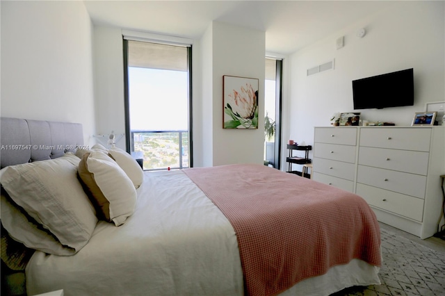 bedroom featuring a wall of windows