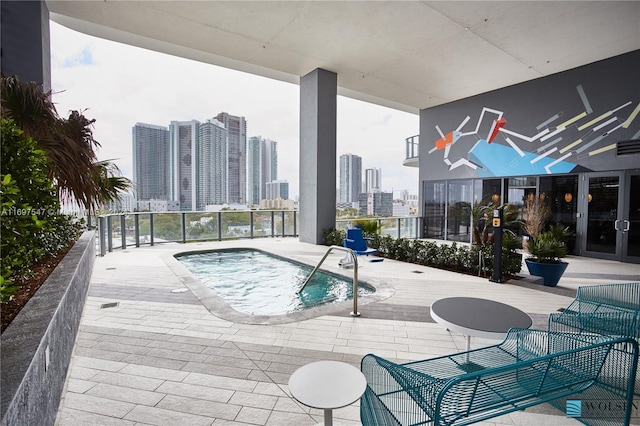 view of swimming pool with a hot tub