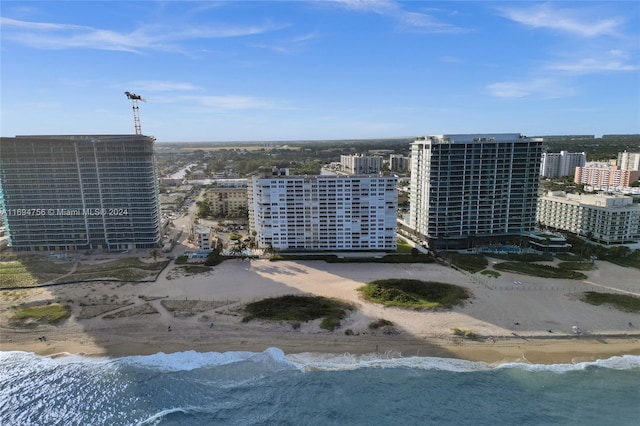 aerial view with a water view and a beach view