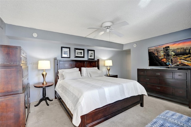 carpeted bedroom featuring a textured ceiling and ceiling fan