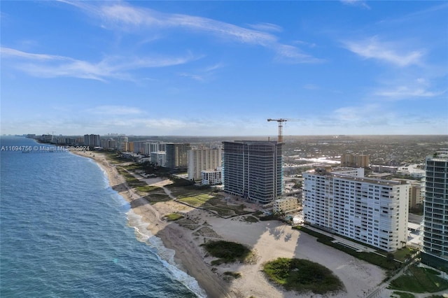 birds eye view of property featuring a beach view and a water view