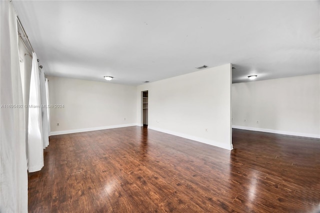 empty room featuring dark wood-type flooring