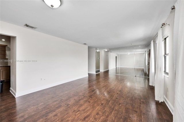 spare room with dark hardwood / wood-style flooring