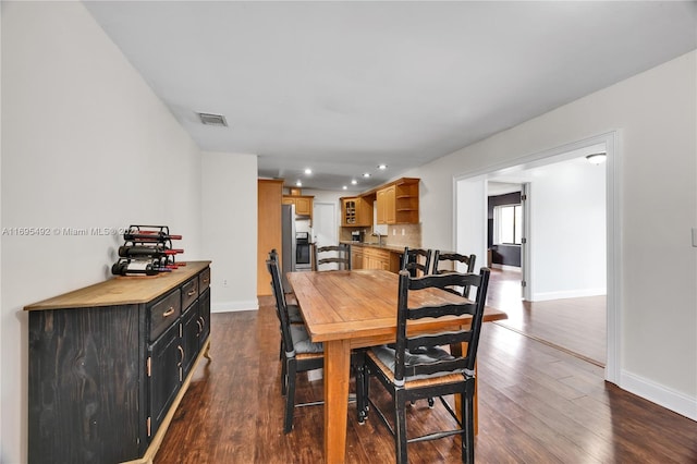 dining space with dark hardwood / wood-style floors and sink