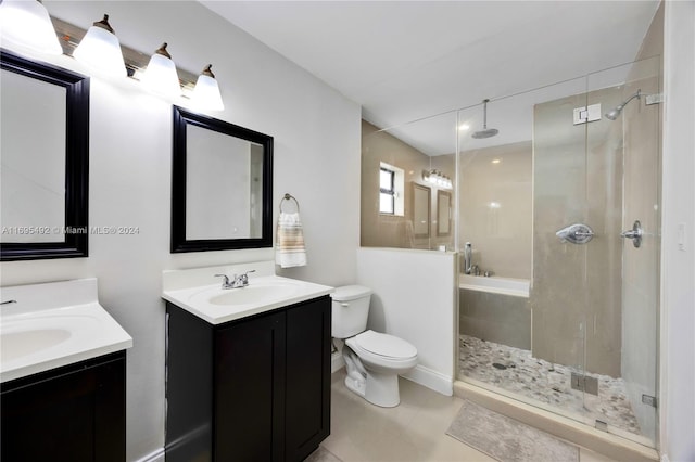 bathroom with tile patterned flooring, vanity, toilet, and walk in shower