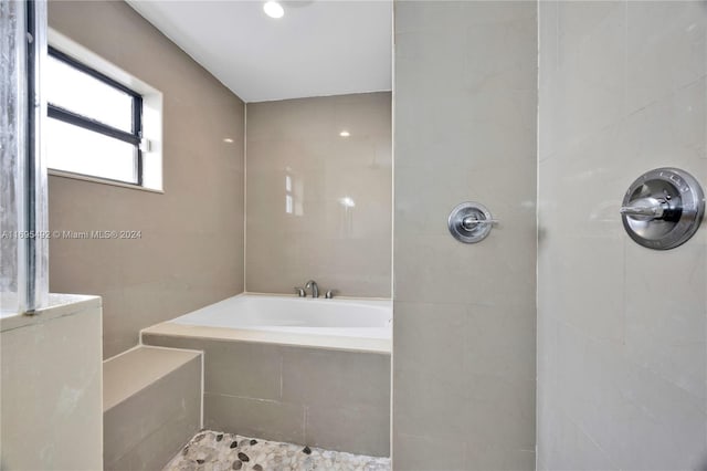 bathroom featuring plus walk in shower