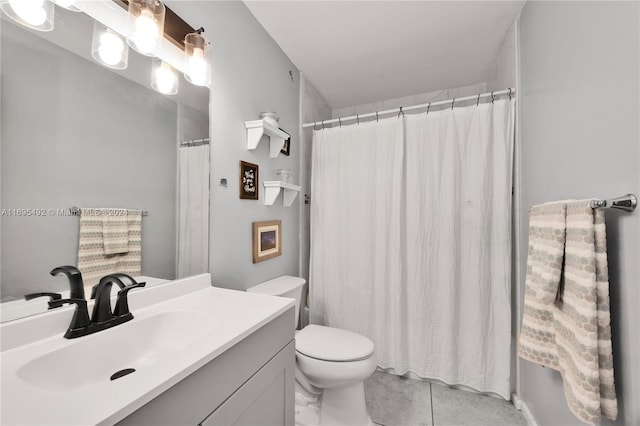 bathroom featuring tile patterned floors, vanity, and toilet