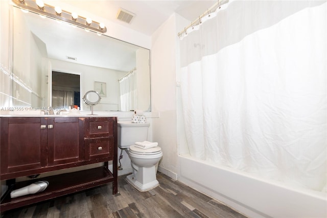 full bathroom with hardwood / wood-style flooring, vanity, toilet, and shower / bath combo with shower curtain