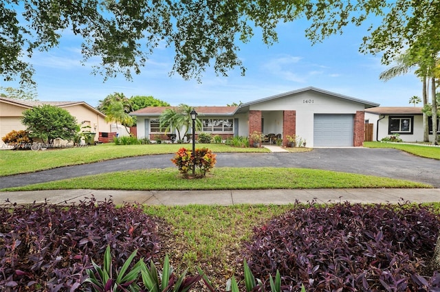 single story home with a garage and a front yard