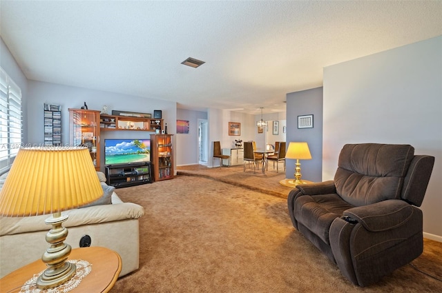 carpeted living room with a textured ceiling