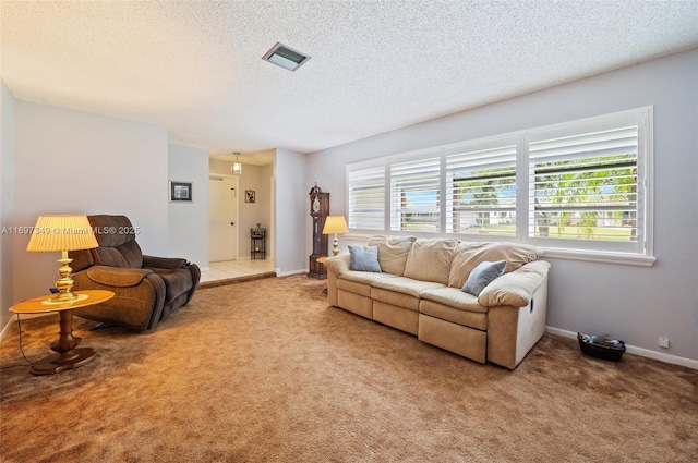 carpeted living room with a textured ceiling