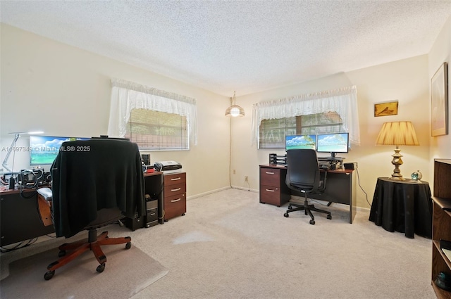 carpeted office space featuring a textured ceiling