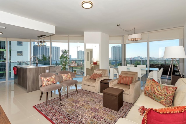 living room featuring a wall of windows, light tile patterned floors, a wealth of natural light, and a chandelier