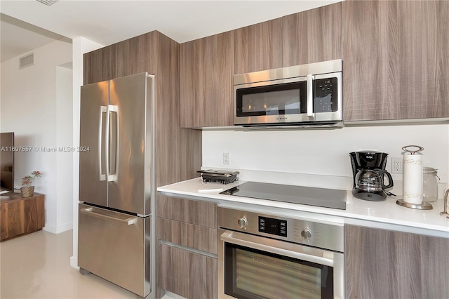 488 NE 18th St Unit 1700, Miami, FL 33132 - kitchen featuring stainless steel appliances, modern cabinets, light countertops, and brown cabinets