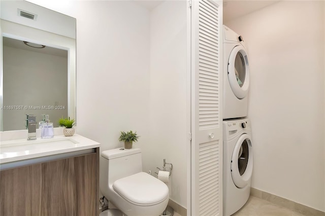 488 NE 18th St Unit 1700, Miami, FL 33132 - bathroom featuring a closet, stacked washer and clothes dryer, vanity, toilet, and baseboards