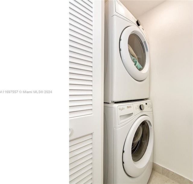 washroom featuring stacked washer and clothes dryer