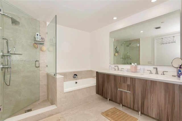 bathroom featuring tile patterned flooring, vanity, and separate shower and tub