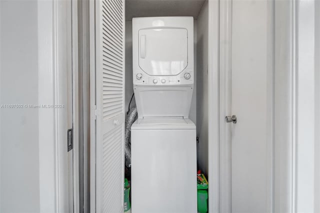 laundry room featuring stacked washer / drying machine