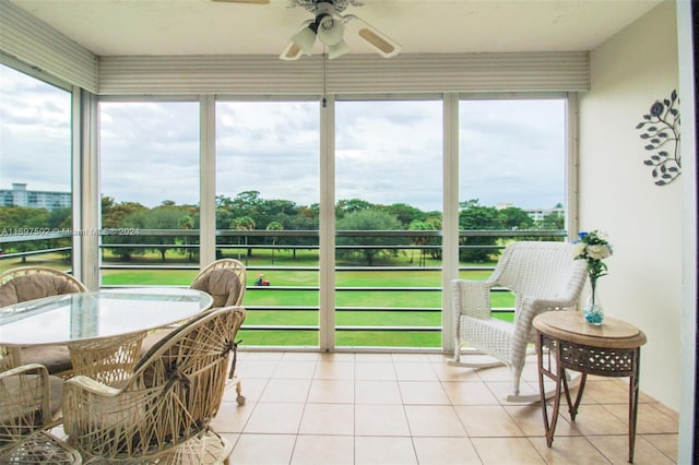 sunroom / solarium featuring plenty of natural light and ceiling fan