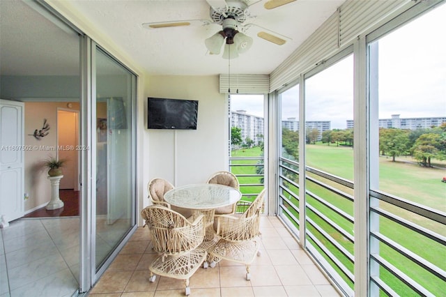 sunroom / solarium featuring ceiling fan