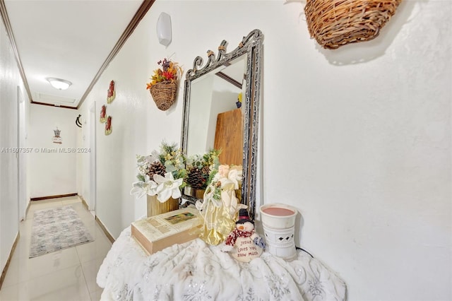 corridor with light tile patterned floors and crown molding