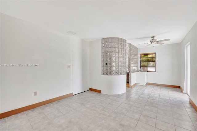 empty room featuring light tile patterned floors and ceiling fan